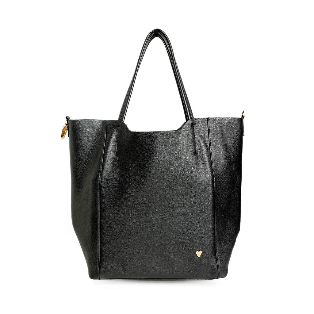 Parker Tote Leather Bag - Black by Nataly Mendez, Genuine leather 21" H, 6.5" D Top: 9.5" W, Bottom: 13" W Handle Drop: 8.5"; Hook closure Flat zipped inside pocket Gold-color hardware Gold heart