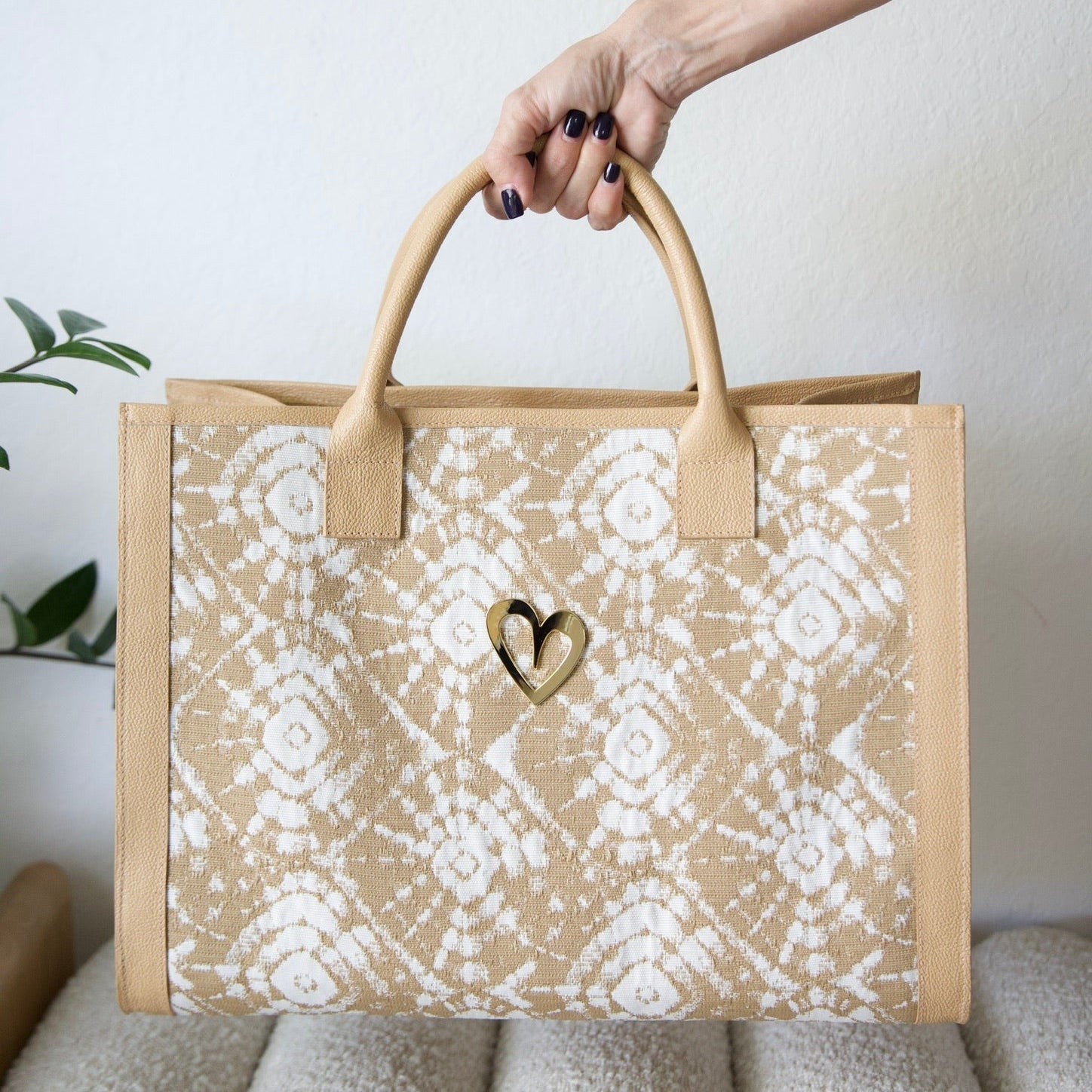 Sienna Beige Tote Bag by Nataly Mendez Genuine leather, Fabric lining, 16 x 12 x 7.5 inches (Length x Height x Width), Magnetic snap closure, Two inside pockets, Built in ring to attach a zippy coin, keychain or hand sanitizer Gold heart