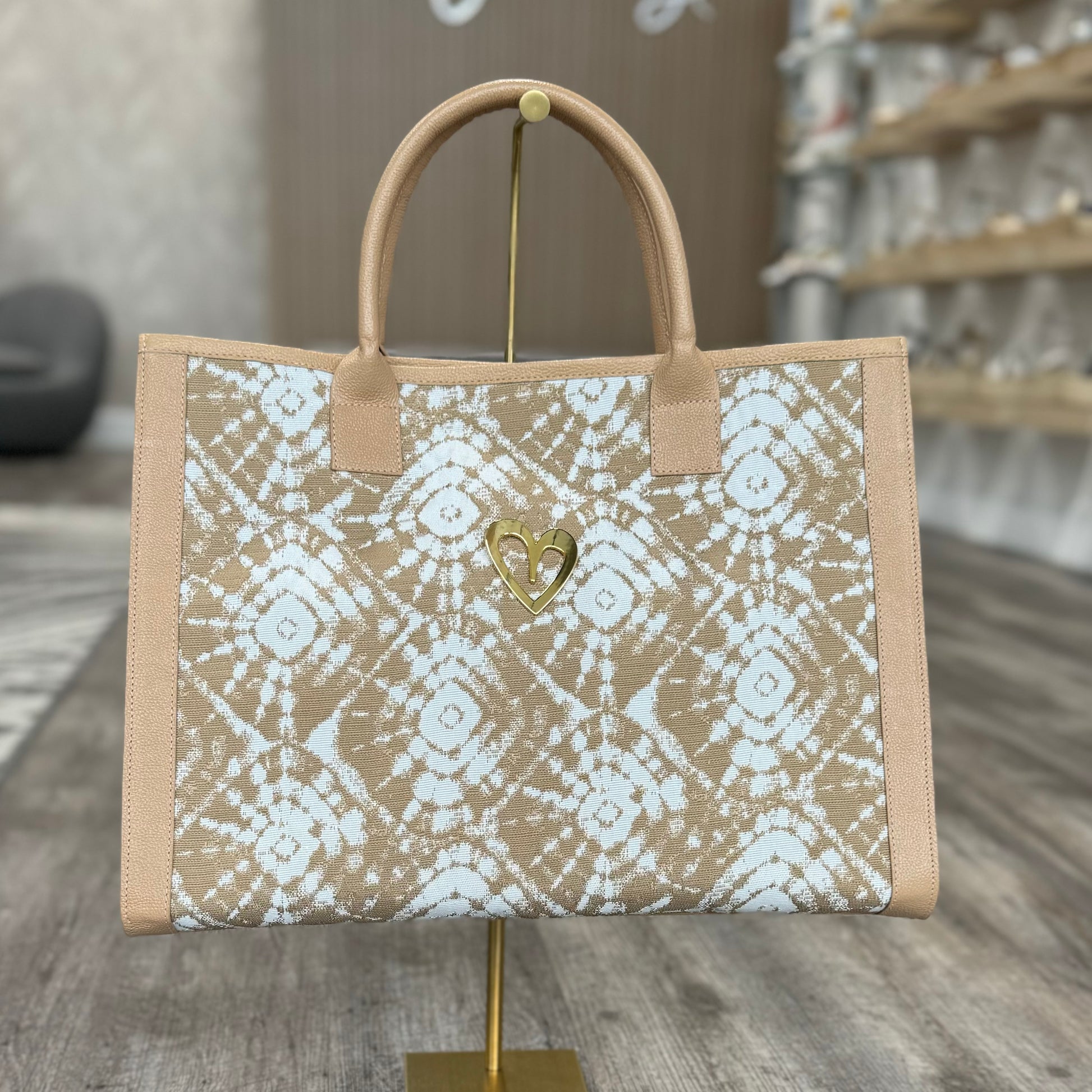 Sienna Tote Bag - Beige by Nataly Mendez, Genuine leather,Fabric lining, 16 x 12 x 7.5 inches (Length x Height x Width), Handle Drop: 6"
Magnetic snap closure.Two inside pockets, Gold heart