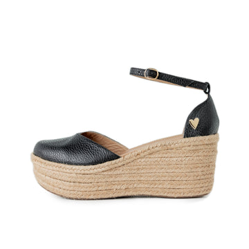 Black Low High Espadrilles by Nataly Mendez Natural jute base Genuine leather upper Genuine leather insole. 100% made in Colombia! 3 inch heel height 1.75 inch platform Comes with strap closure and beige hiladilla laces.