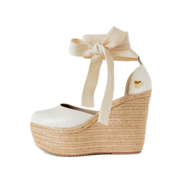 White Espadrilles by Nataly Mendez. Natural jute base Genuine leather upper Genuine leather insole. 100% made in Colombia! 4 inch heel height 1.75 inch platform Comes with strap closure and beige hiladilla laces.